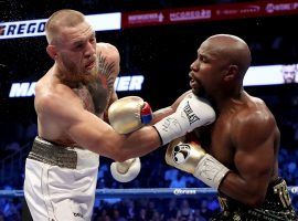 Predictably, bookmakers have made Conor McGregor a heavy favorite over Floyd Mayweather in a hypothetical MMA fight between the two. (Image: Getty)