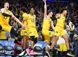 Michigan players celebrate the team’s victory that will send them to the Final Four in San Antonio. (Image: Los Angeles Times)