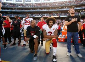 Eric Reid (left) and Colin Kaepernick kneel during the national anthem before a game on September 1, 2016. (Image: Michael Zagaris/Getty)