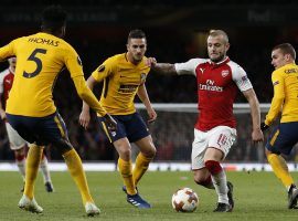 Arsenal’s Jack Wilshere dribbles near Atletico Madrid defenders in the first leg of their Europa League semifinal. (Image: Ian Kington/AFP/Getty)