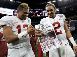 Tua Tagovailoa, left, and Jalen Hurts celebrate after winning the National Championship in January, but are now locked into a fierce battle for the starting quarterback position. (Image: Getty)