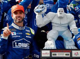 Jimmie Johnson poses next to last year’s trophy he won at Dover International Speedway. (Image: Getty)