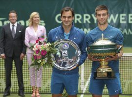 Borna Coric (right) holds his trophy after defeating Roger Federer (left) in the final of the Gerry Weber Open in Halle, Germany on Sunday. (Image: Friso Gentsch/DPA/AP)