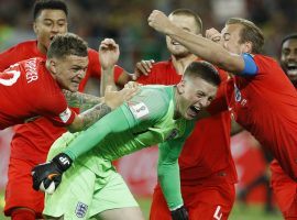 Goalkeeper Jordan Pickford celebrates with his teammates following England’s shootout victory over Colombia in the 2018 World Cup. (Image: Victor R. Caivano/AP)