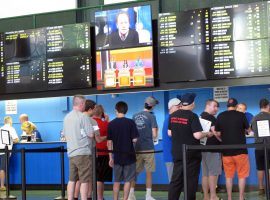 Gamblers line up to play bets at the sportsbook at Monmouth Park Racetrack in New Jersey. (Image: Wayne Parry/AP)