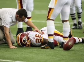 Washington Redskins running back Clinton Portis is treated by team medical personnel during a game against the Atlanta Falcons. (Image: Getty)