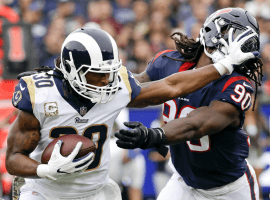 Todd Gurley of the Los Angeles Rams eludes Jadeveon Clowney of the Houston Texans during a 2017 regular season NFL game. (Image: Alex Gallardo/AP)