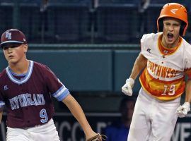 Ryan Selveggi (right) of Post Oak, Texas celebrates after scoring a run following a wild pitch from Coventry, Rhode Island pitcher Tommy Turner (left) in a pool play game at the Little League World Series on Thursday. (Image: Gene J. Puskar/AP)