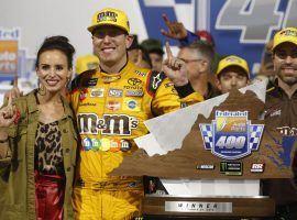 Kyle Busch poses with his wife and the winner’s trophy after taking first place in the Federated Auto Parts 400 at Richmond Raceway on Saturday. (Image: AP)