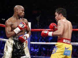 Floyd Mayweather and Manny Pacquiao size each other up during their first fight, which took place in May 2015. (Image: John Gurzinski/AFP/Getty)