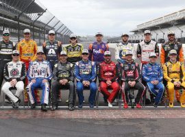 The 16 drivers who have qualified for the NASCAR Cup Series Playoffs pose together before the South Point 400 at Las Vegas Motor Speedway. (Image: Getty)