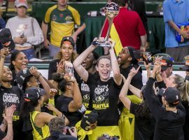 MVP Breanna Stewart lifts the trophy and celebrates with her teammates after the Seattle Storm swept the Washington Mystics to win the WNBA Finals. (Image: Bettina Hansen/Seattle Times)