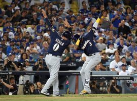 Brewers infielder Orlando Arcia (3) celebrates with third base coach Ed Sedar (0) during Milwaukee’s 4-0 win over the Los Angeles Dodgers in Game 3 of the 2018 NLCS. (Image: Getty)