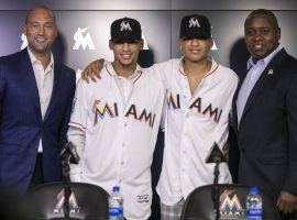 Derek Jeter (left) posts with Victor Victor Mesa, Victor Mesa Jr., and Michael Hill (right) at a press conference announcing the Miami Marlins’ signing of the Mesa brothers. (Image: Matias J. Ocner/Miami Herald)