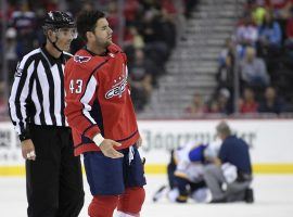 Tom Wilson is led off the ice by an official after delivering a hit to St. Louis Blues center Oskar Sundqvist on Sunday. (Image: Nick Wass/AP)