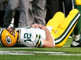 Green Bay quarterback Aaron Rodgers lies on the turf after suffering a broken right collarbone that effectively ended his season. (Image: AP)