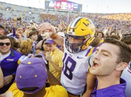 LSU fans storm the field to celebrate with the players, who upset No. 2 Georgia, 36-16. (Image: AP)