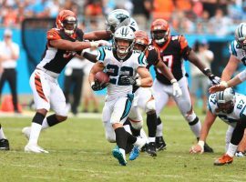Christian McCaffrey evades tacklers in a game against the Cincinnati Bengals. (Image: Jeremy Brevard-USA TODAY Sports)