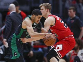 The Celtics' Jayson Tatum drives by Lauri Markkanen from the Bulls during a laugher in Chicago. (Image: Kamil Krzaczynski/AP)