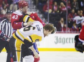 Tom Wilson (43) of the Washington Capitals fights with Jamie Oleksiak (6) of the Pittsburgh Penguins during Wednesdayâ€™s NHL regular season game. (Image: Alex Brandon/AP)