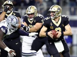 Drew Brees of the New Orleans Saints drops back to pass against the Dallas Cowboys in Arlington, Texas. (Image: Ronald Martinez/Getty)