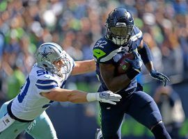 Seattle Seahawks running back Chris Carson slips by tackler Sean Lee (50) from the Dallas Cowboys during a game in Seattle in September. (Image: Olivia Vanni/The Everett Herald)