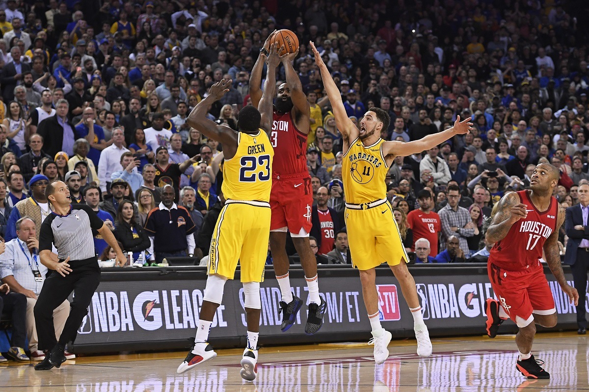 The Houston Rockets James Harden shoots the game winning shot over defenders Draymond Green (23) and Klay Thompson (11) from the Golden State Warriors. (Image: Jose Carlos Fajardo/Bay Area News Group)