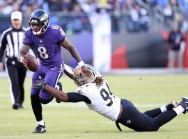 Baltimore Ravens quarterback Lamar Jackson evades a tackler against the New Orleans Saints. (Image: Mitch Stringer/USA Today Sports)
