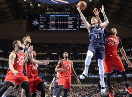 Swingman Luka Doncic (11) from the Dallas Mavericks drives by Toronto Raptors forward Norman Powell (24) at the American Airlines Arena in Dallas. (Image: AP)