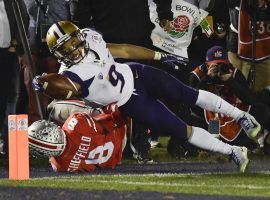 The Washington Huskies couldnâ€™t quite come back to win the 2019 Rose Bowl, but three late touchdowns by running back Myles Gaskin (9) stopped Ohio State from covering the spread. (Image: Mark J. Terrill/AP)