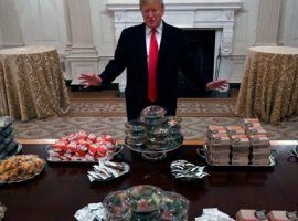 President Donald Trump stands before a meal of hamburgers and pizza he said he bought for the Clemson football team. (Image: AP)