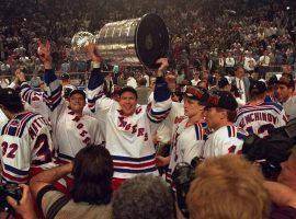 New York Rangers captain Mark Messier holds the Stanley Cup while celebrating with teammates at Madison Square Garden in New York City 1994. (Image: David E. Klutho/Getty)