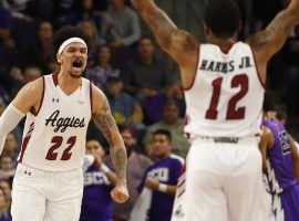 New Mexico State's Eli Chuha (22) is greeted by teammate AJ Harris (12) after he scored a layup against GCU at Grand Canyon University Arena in Phoenix, AZ. (Image: Patrick Breen/The Republic)