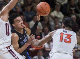 Virginia Tech's Kerry Blackshear (24) and Ahmed Hill (13) defend Duke's Tre Jones during an ACC game in Blacksburg, VA. (Image: Lee Luther Jr/AP)