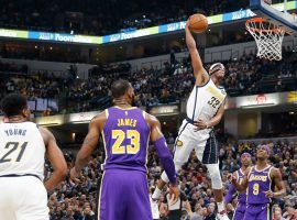 Indiana Pacers center Myles Turner soars for a dunk as LeBron James from the LA Lakers looks on during a game in Indianapolis. (Image: Jeff Haynes/Getty)