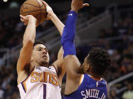 Devin Booker of the Phoenix Suns rises for a shot over Dennis Smith of the New York Knicks at Talking Stick Resort Arena in Phoenix, Arizona. (Image: AP)