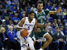 Buffalo guard CJ Massinburg (5) drives by Eastern Michigan's Elijah Minnie (5) at Alumni Arena in Buffalo, NY. (Image: Jeffrey P. Barnes/AP)