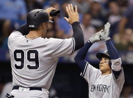 After NY Yankees RF Aaron Judge (99) hits a home run, he is congratulated by teammate Ronald Torreyes. (Image: Rich Schultz/Getty)