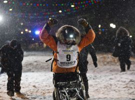 Peter Kaiser of Bethel, Alaska crosses the finish line in Nome to win the 2019 Iditarod Sled Dog race. (Image: Marc Lester/Anchorage Daily News)