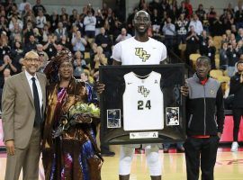 UCF head coach Johnny Dawkins with Tacko Fall, his mother Marianne Sene, and brother Fallou at CFE Arena in Orlando, Florida. (Image: Stephen M. Dowell/Orlando Sentinel)
