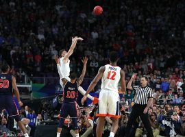 Virginia's Kyle Buy shoots a three-pointer over Auburn's Samir Doughty in a Final Four game at US Bank Stadium in Minneapolis, Minnesota. (Image: Getty)