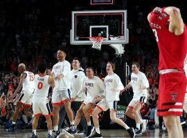 The Virginia Cavaliers celebrate winning the national championship in overtime, while a dejected Matt Mooney (13) from Texas Tech tries to hide at US Bank Stadium in Minneapolis. (Image: Getty)