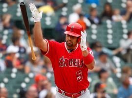 Albert Pujols, first baseman from the LA Angels, tosses his bat after hitting a home run that secured his 2,000 career RBI during a game against the Detroit Tiger in Detroit, MI. (Image: Paul Sancya/AP)