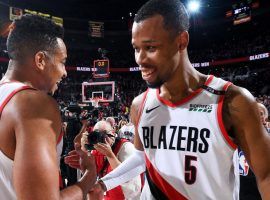 Portlandâ€™s CJ McCollum (right) congratulates teammate Rodney Hood (right) for helping the Blazers beat the Denver Nuggets in 4 OT thriller in Portland, OR. (Image: Getty)