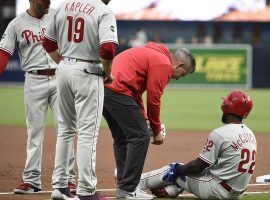 Training staff attend to Phillies CF Andrew McCutchen after he injures his knee in a rundown against the San Diego Padres in Petco Park. (Image: AP)