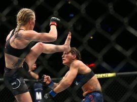 Valentina Shevchenko (left) lands a head kick that resulted in a knockout victory over Jessica Eye. (Image: Rey Del Rio/Getty)