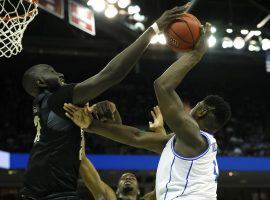 UCF center Tacko Fall rejects Duke's Zion Williamson during a 2019 March Madness college basketball game. (Image: Kevin C. Cox/Getty)