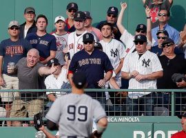 Red Sox fans in the bleachers at Fenway Park shout pleasantries to Yankees outfielder Aaron Judge. (Image: Michael Dwyer/AP)