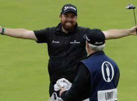Shane Lowry celebrates winning the Open Championship with his caddy on Sunday at Royal Portrush. (Image: AP)