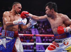 Manny Pacquiao (right) scored a split decision victory over Keith Thurman to win the WBA welterweight championship on Saturday night. (Image: John Locher/AP)